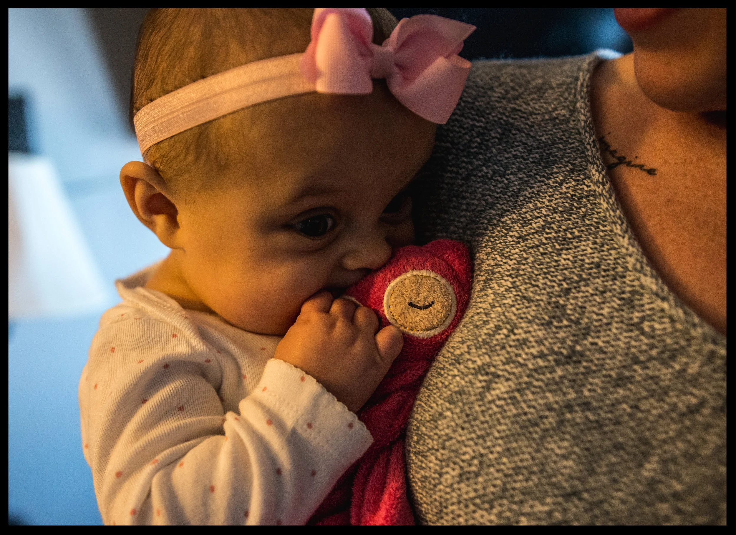 Baby girl chewing on stuffed pink owl, color, Aurora, Colorado