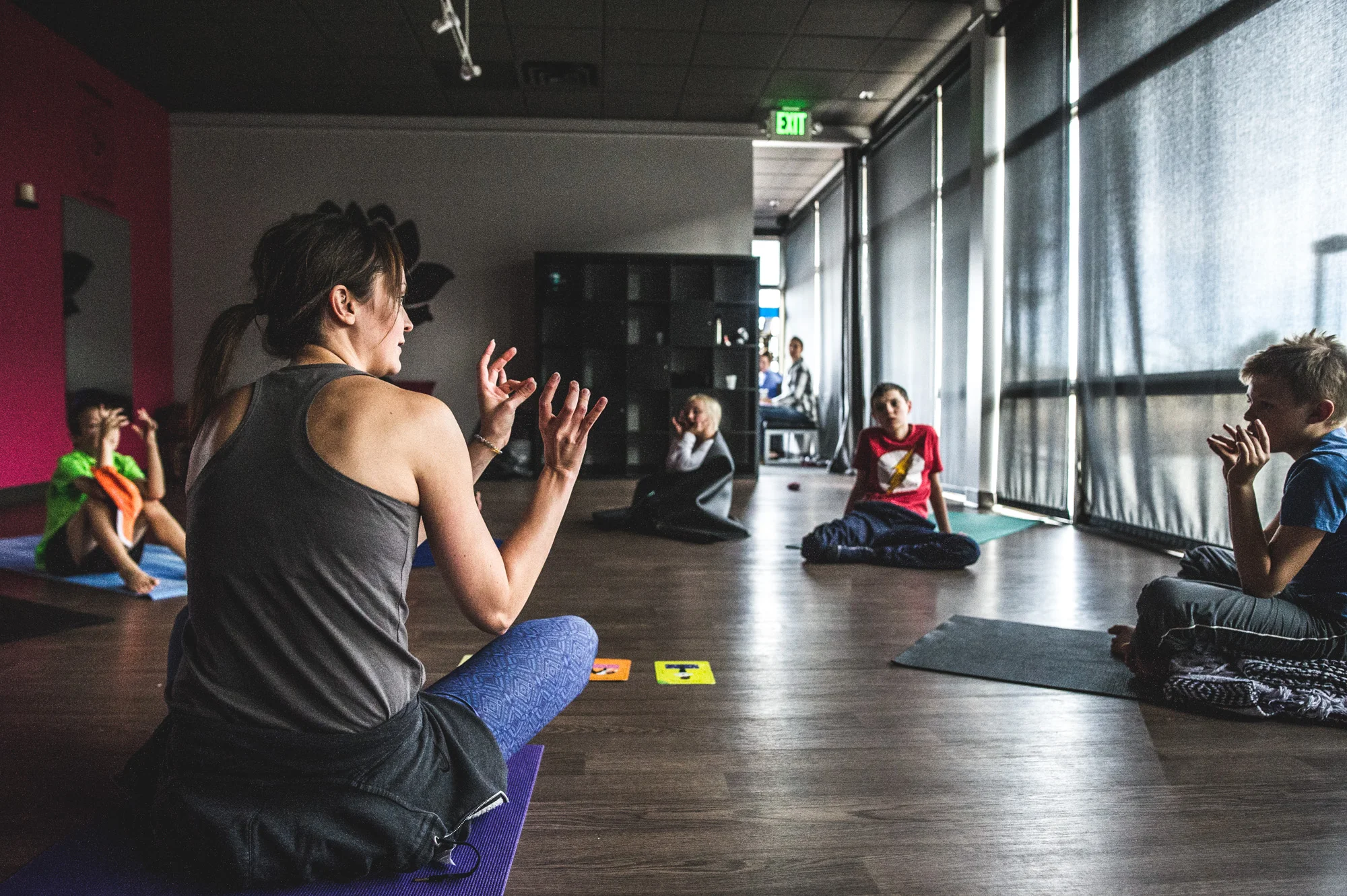 Yoga instructor teaches her students "SA TA NA MA" in Highland's Ranch, Colorado, color