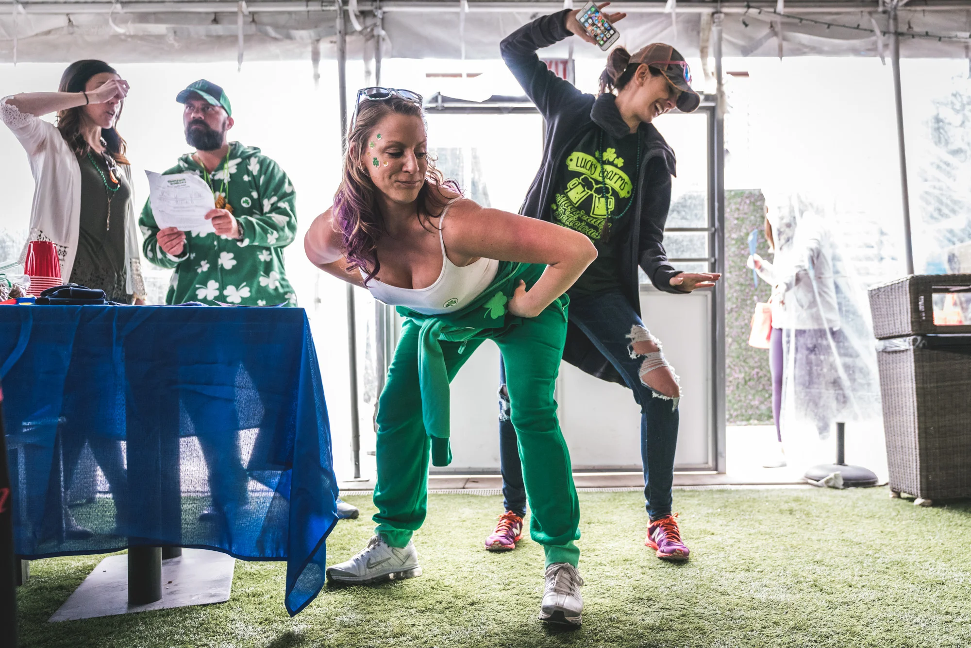 Two women dance together while wearing Saint Patrick's Day themed outfits during the ASC Shamrock Stumble in Littleton, CO