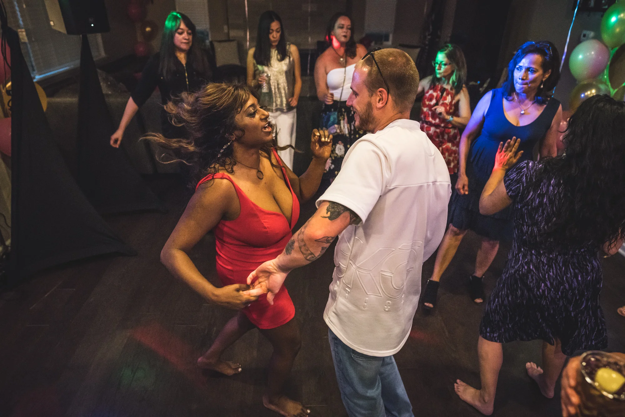Girl in a red dress dances as her hair flies behind her