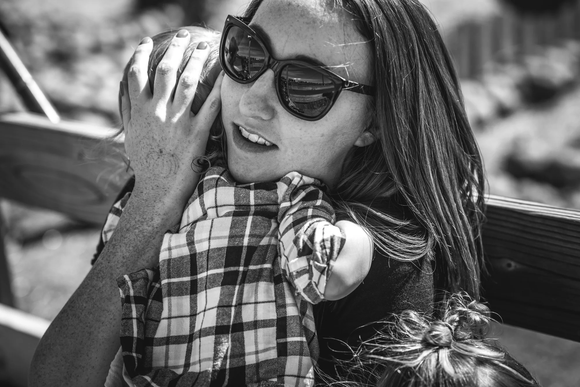 Mother smiles and holds her baby daughter close