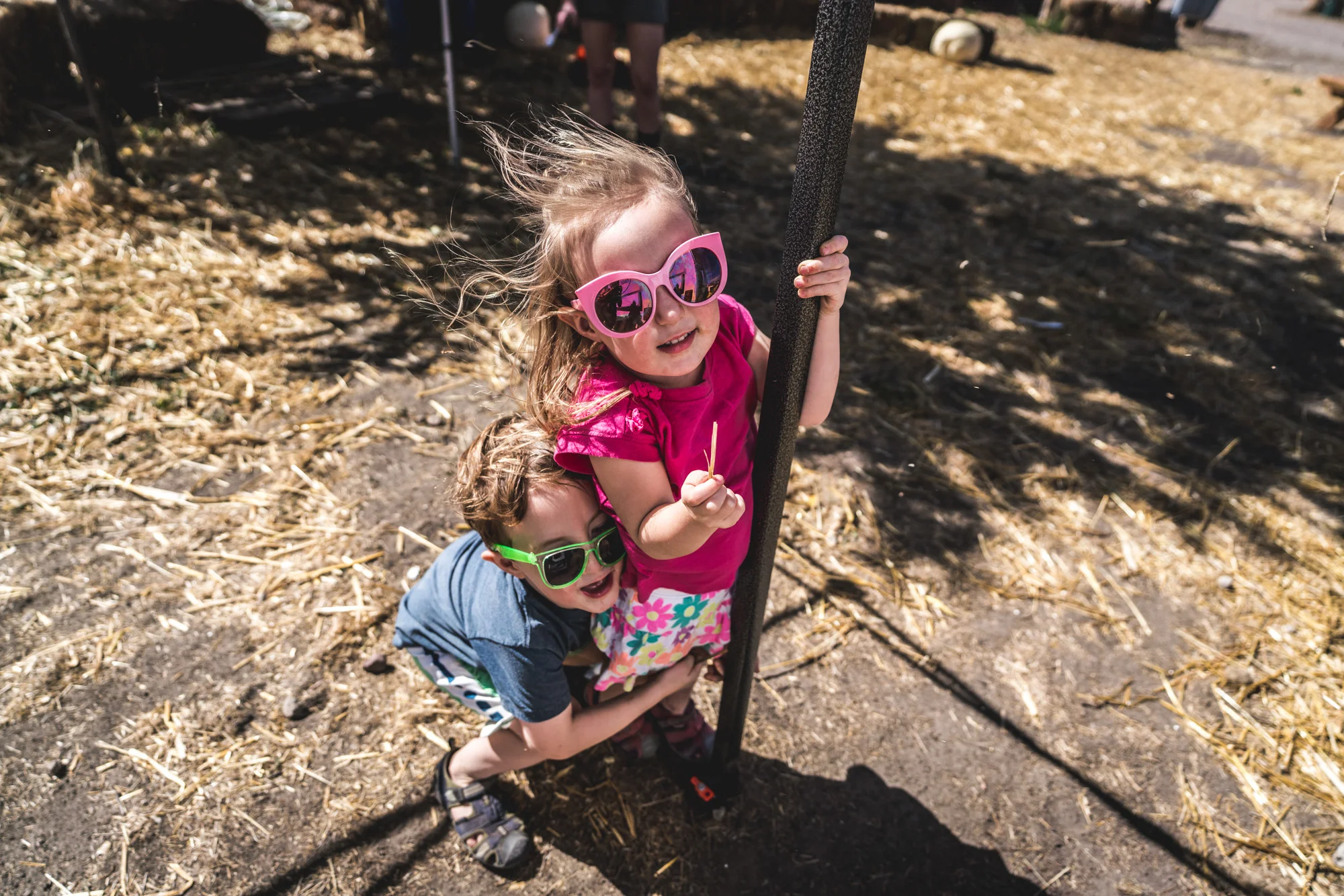Brother and sister play at a pumpkin patch