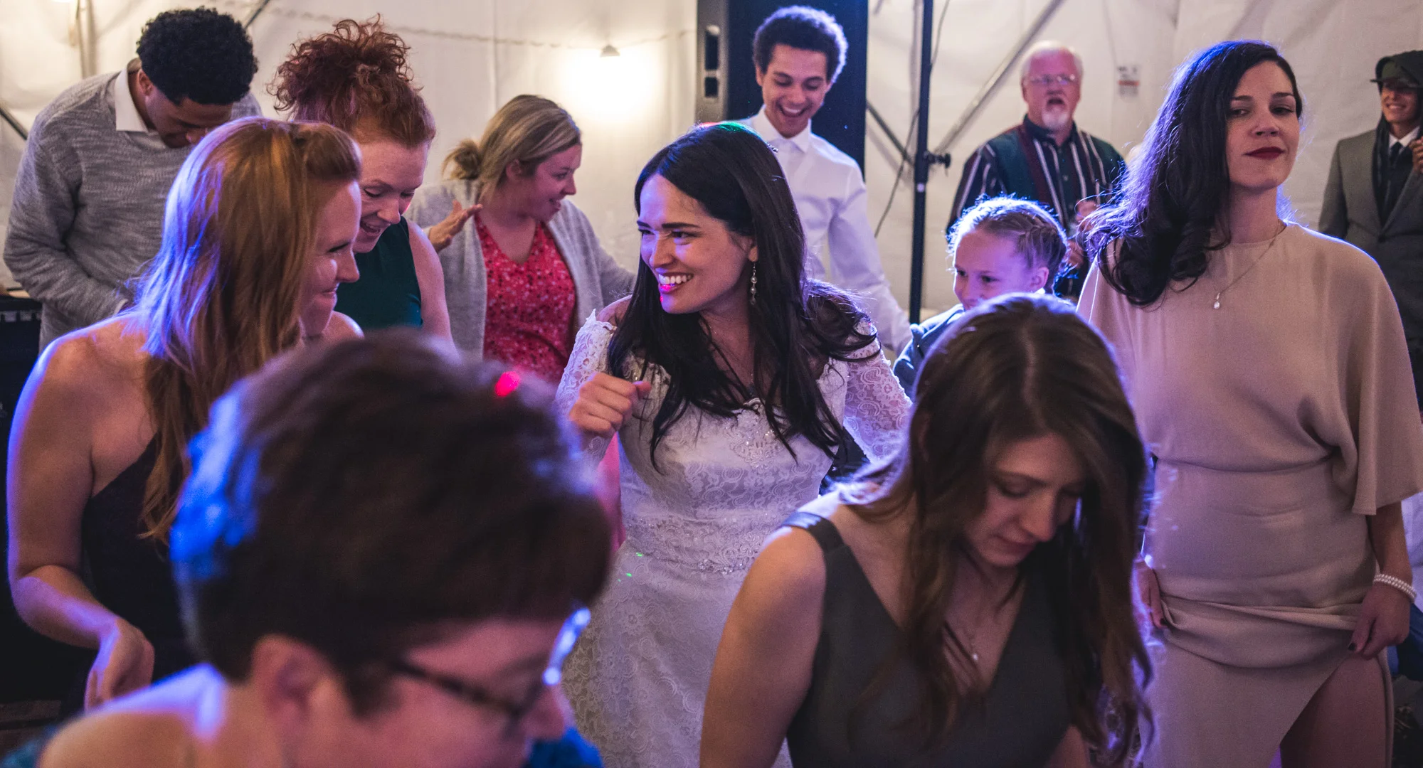 Bride dances with all of her guests on the dance floor at her wedding reception