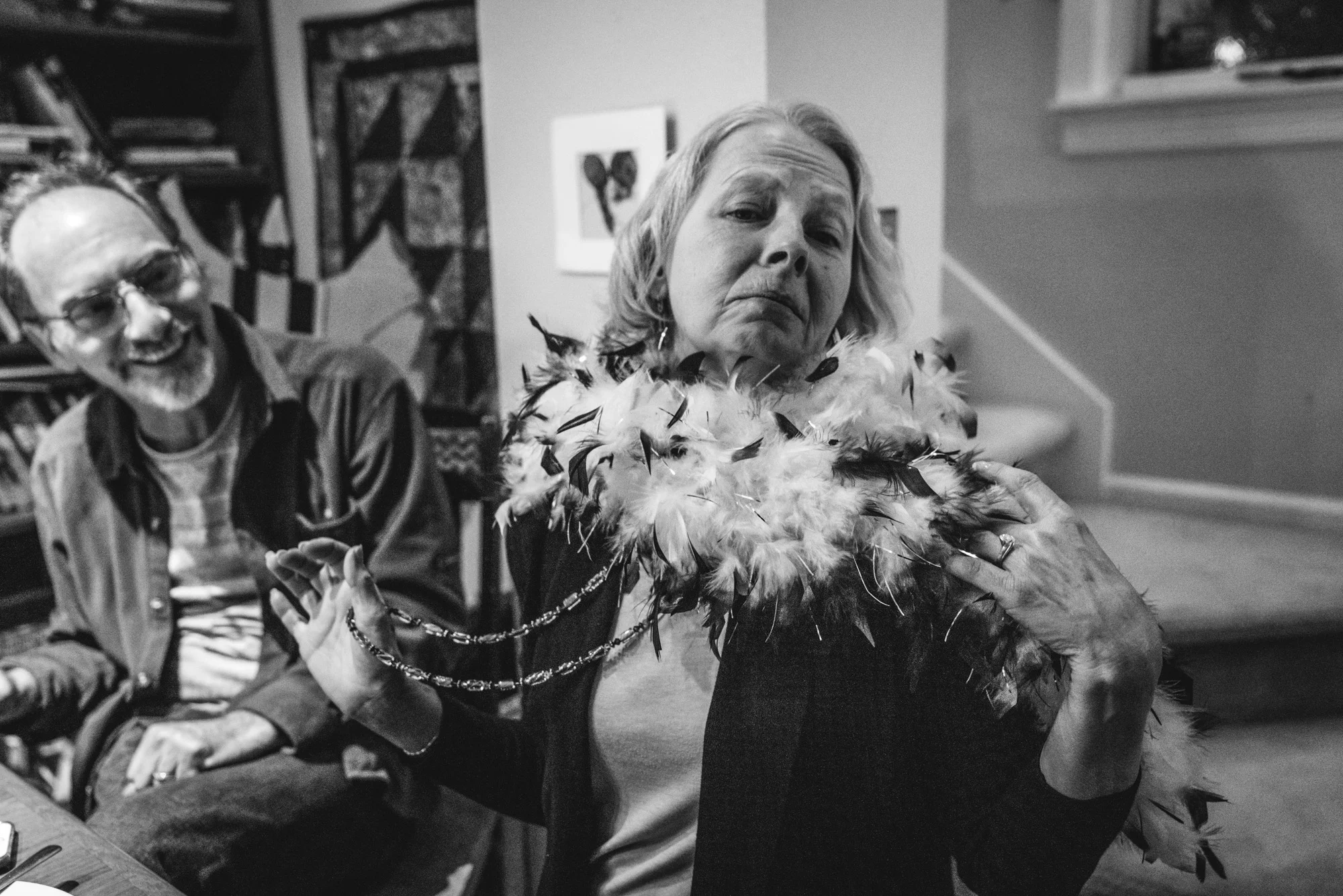 A woman wearing a feather boa poses for the camera