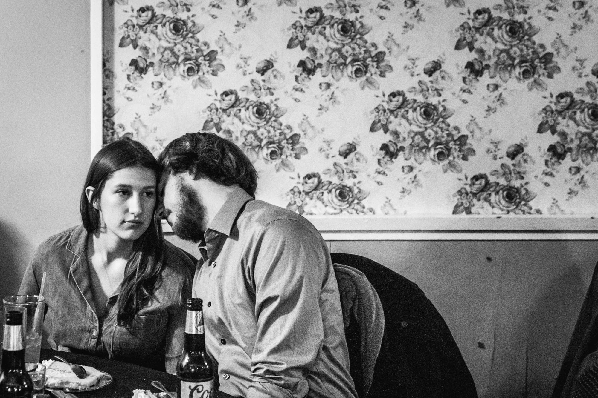 Couple at a wedding nestle close together