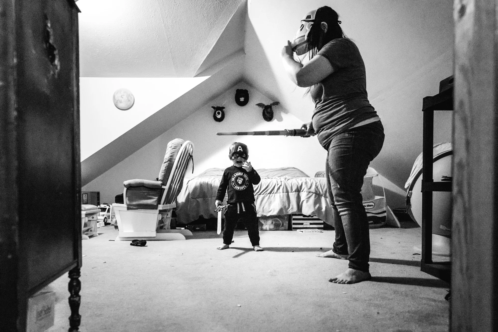 Mother and son both wear a mask and sword in mom’s bedroom