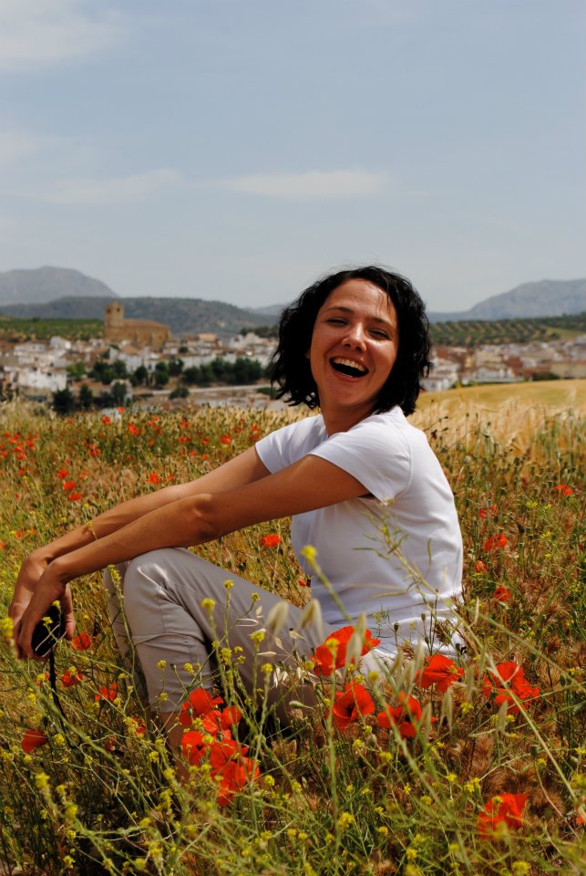 Denver Documentary family photographer Samantha Hines sitting in a field of poppies