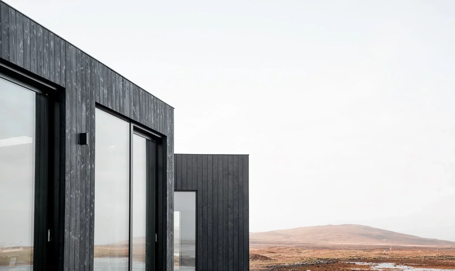 Architect-designed prefabricated home set in woodland with panoramic windows