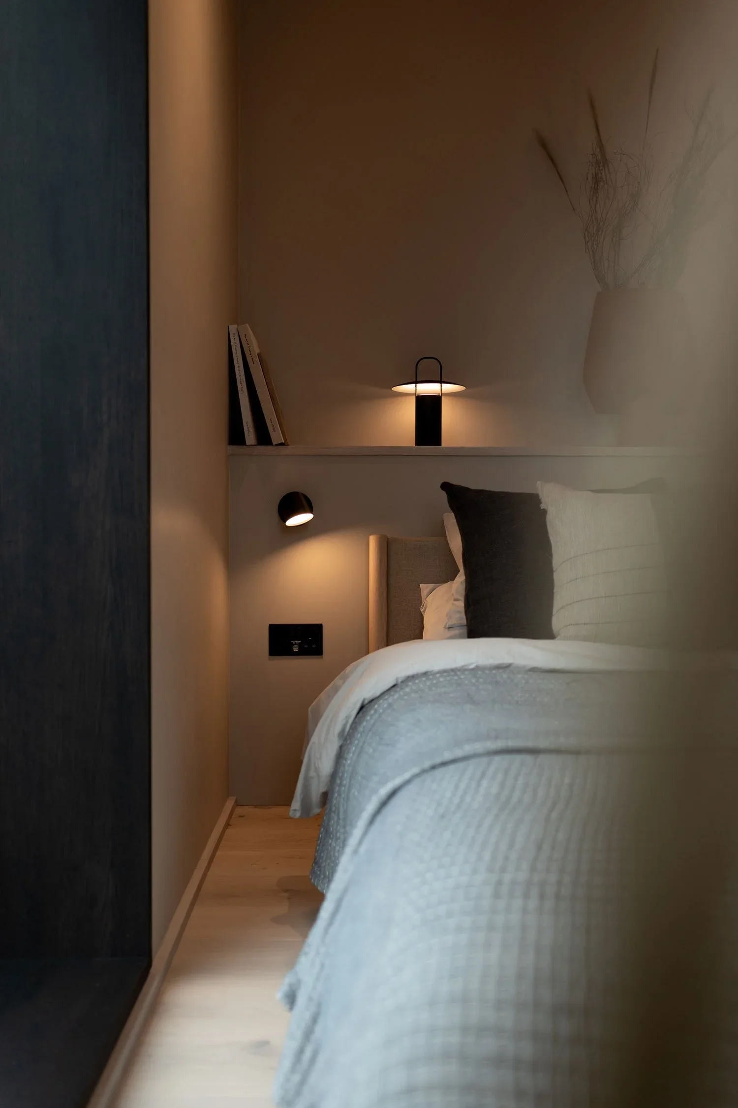 Hotel cabin bedroom with large window and calm, natural materials