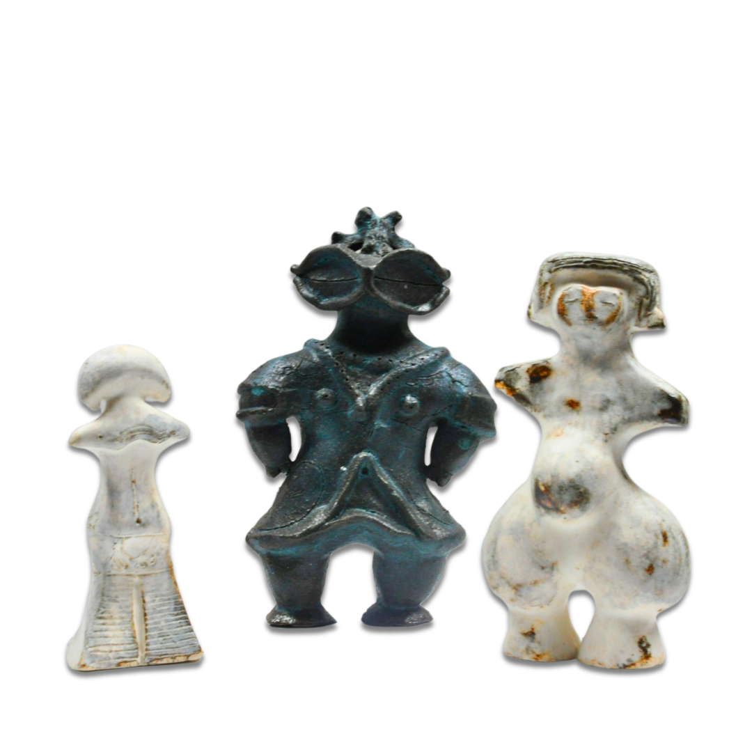 A shiny metal pipe connected to a metal flange inside a dark enclosure.