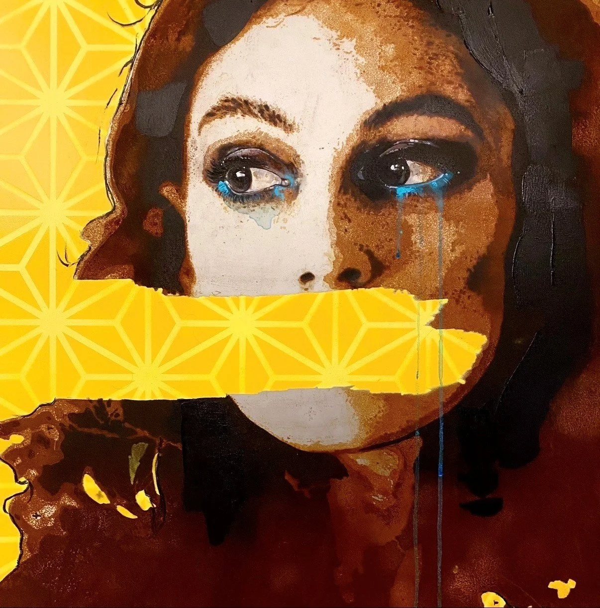 Street art mural of a woman's face with colorful hair, painted on a dark background.