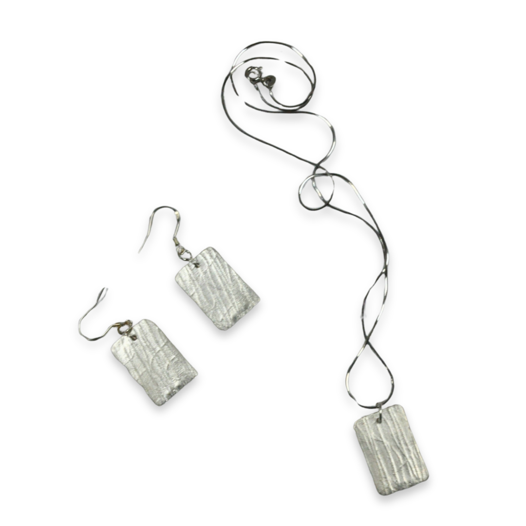 Silver necklace with a large oval green gemstone pendant.