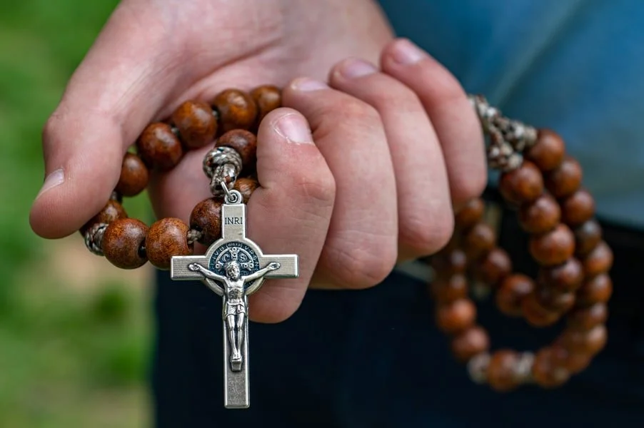 Holding a rosary.jpg