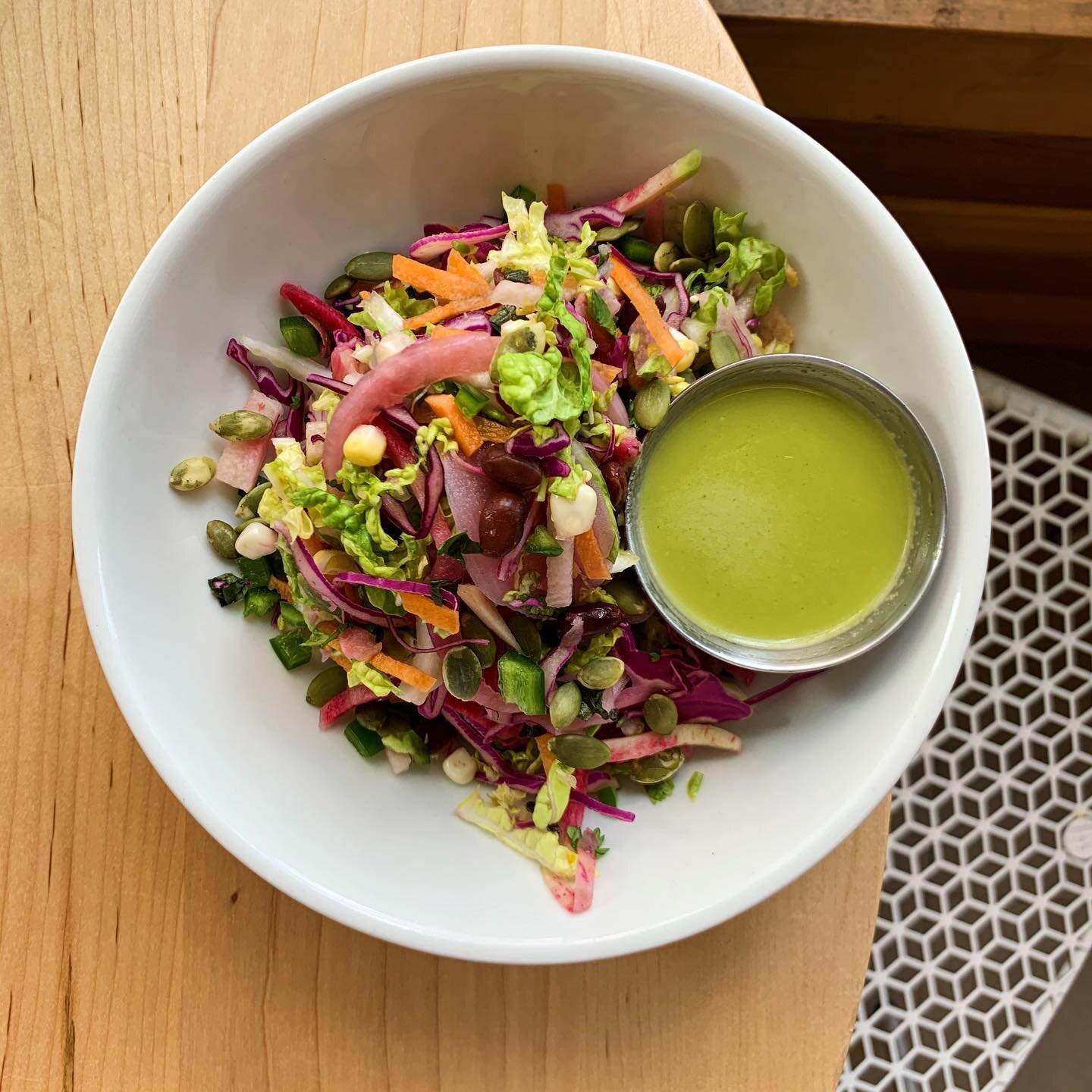 We are back! 🚫 🖥 😩 And so is one of our fave summer sides - Rainbow Slaw. This crunchy fresh salad is packed with Napa and red cabbage, carrots, watermelon radish, black beans, fresh corn, fresh herbs, pickled onions and pumpkin seeds, and drizzle