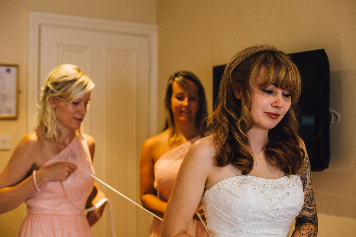 Bride Putting Dress On 