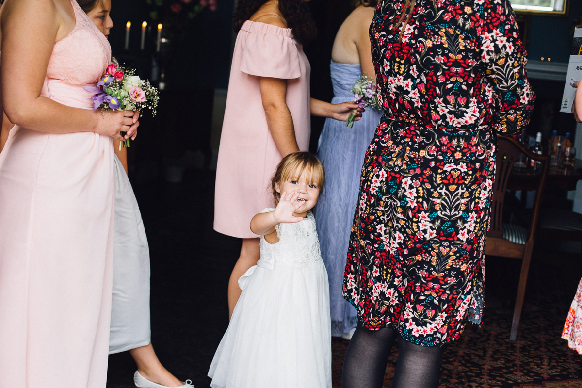 Younger Bridesmaid Waving to Photographer