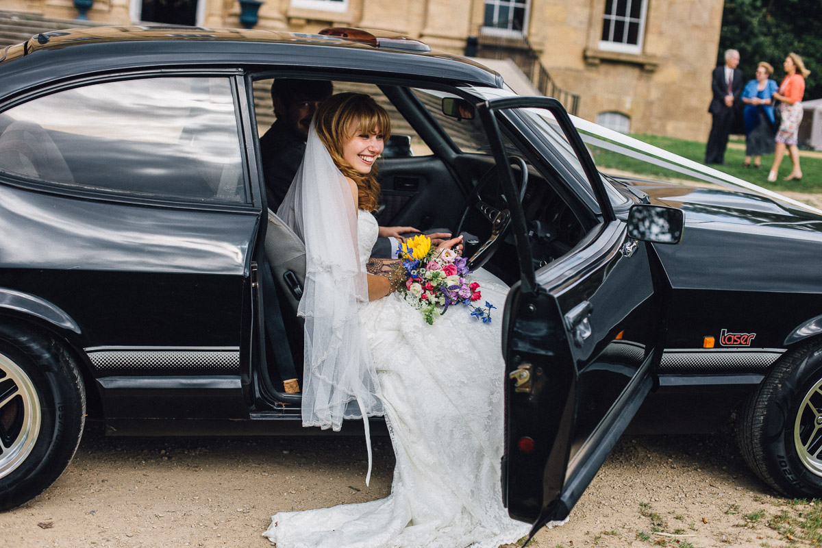 Bride Sitting in Wedding Car Kings Weston House