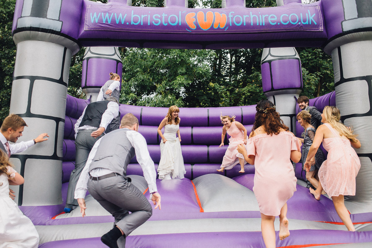 Bridal Party Jump onto Bouncy Castle