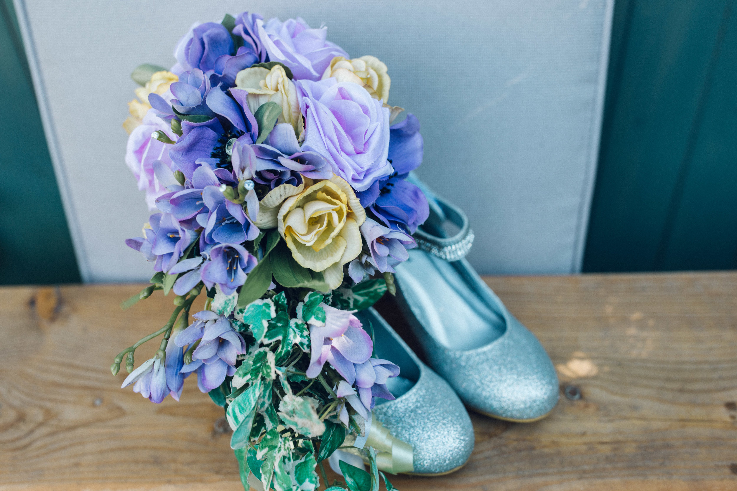 Pastel coloured artificial bouquet and glittery bride shoes 