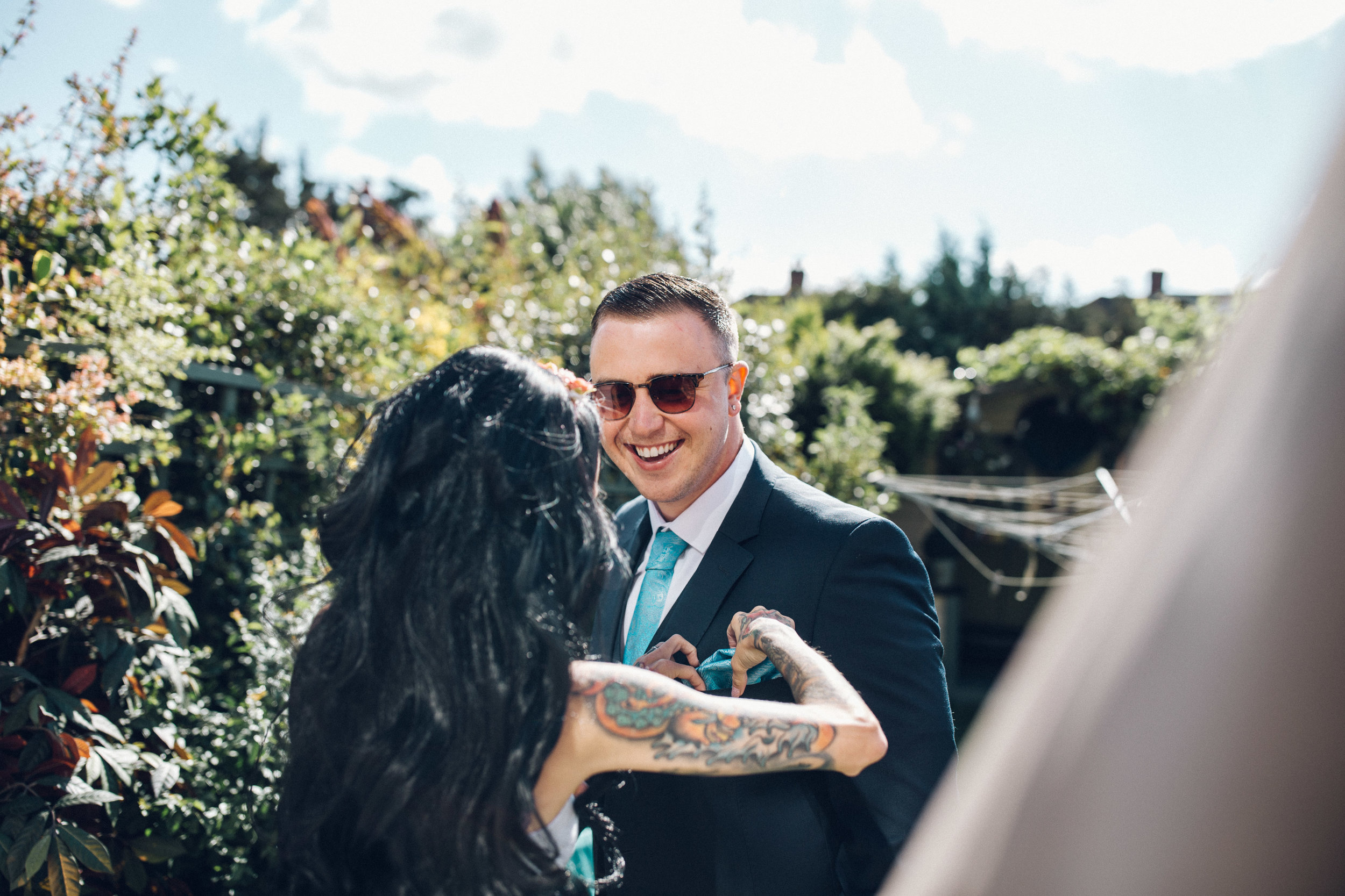 Bride sorting out bridesman pocket square