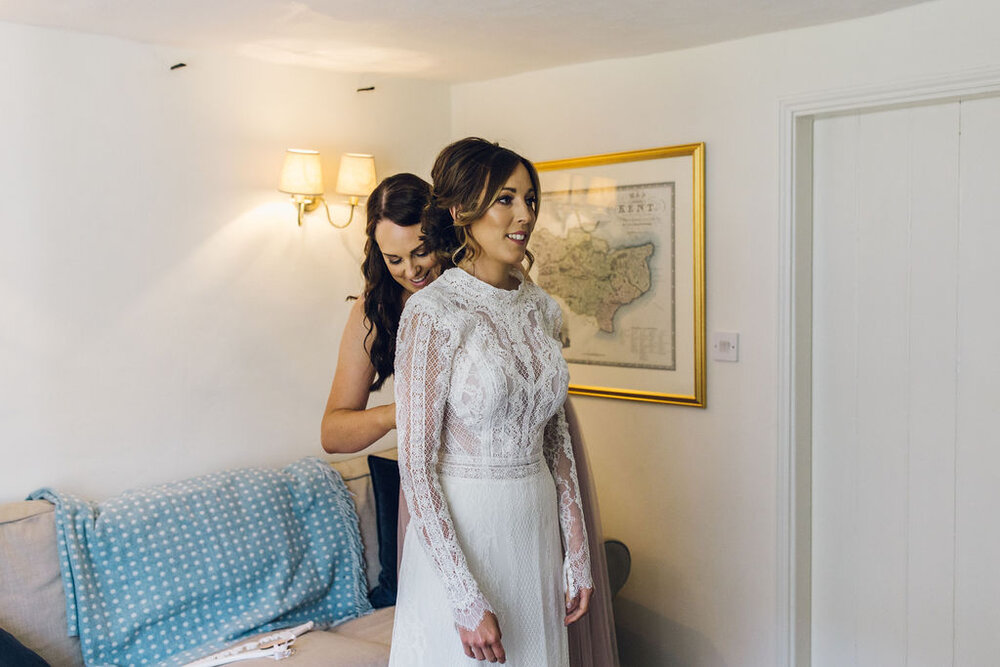 Relaxed Wedding at the Dreys, Kent -Bride Putting Dress On