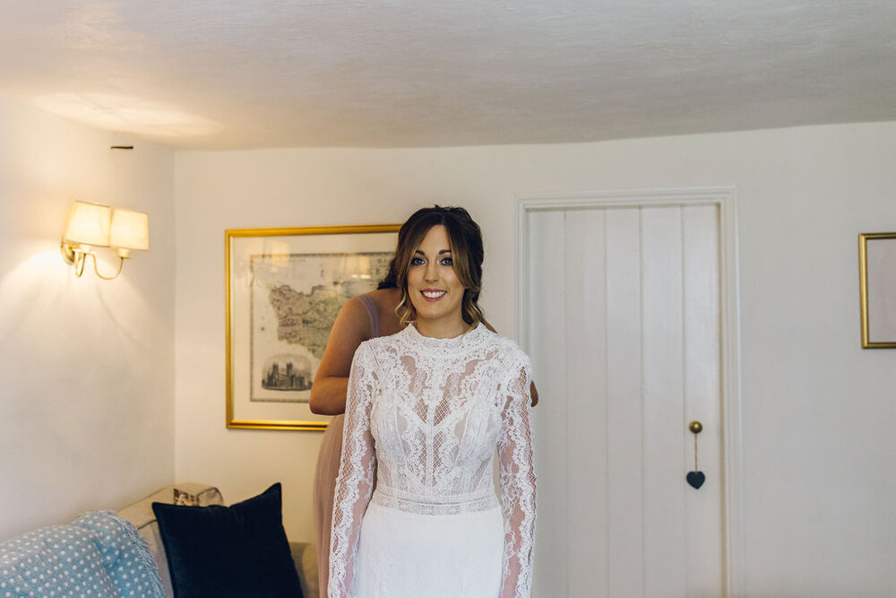 Relaxed Wedding at the Dreys, Kent -Bride Putting Dress On 