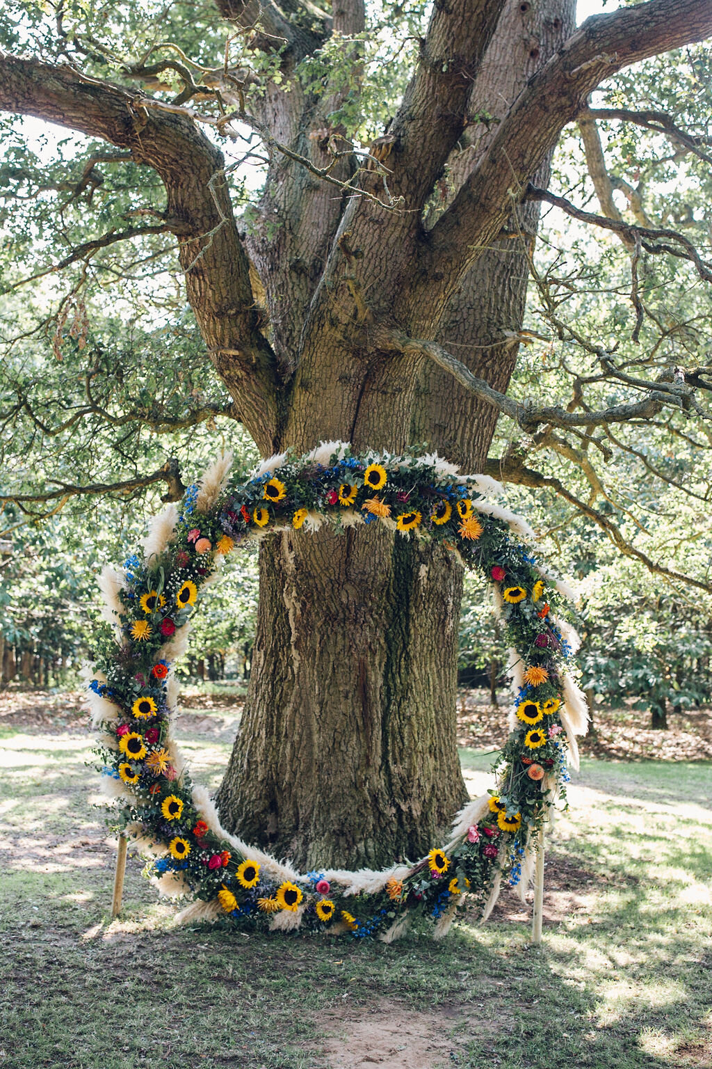 Colourful Festival Wedding Essex - Bright Floral Hoop Ceremony Backdrop