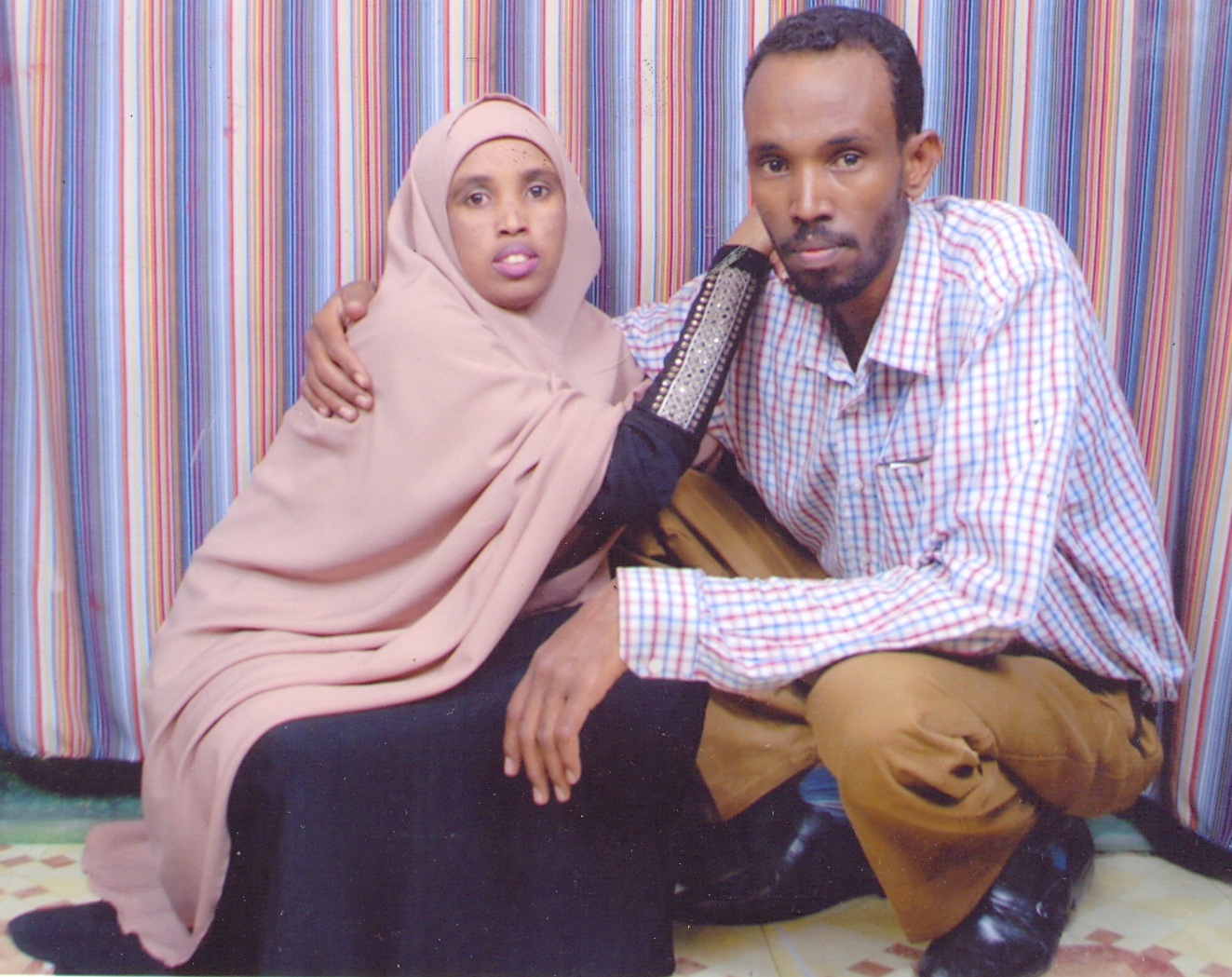 Commander Peacock and his wife, The Victim, in a Nairobi photo studio. 2011