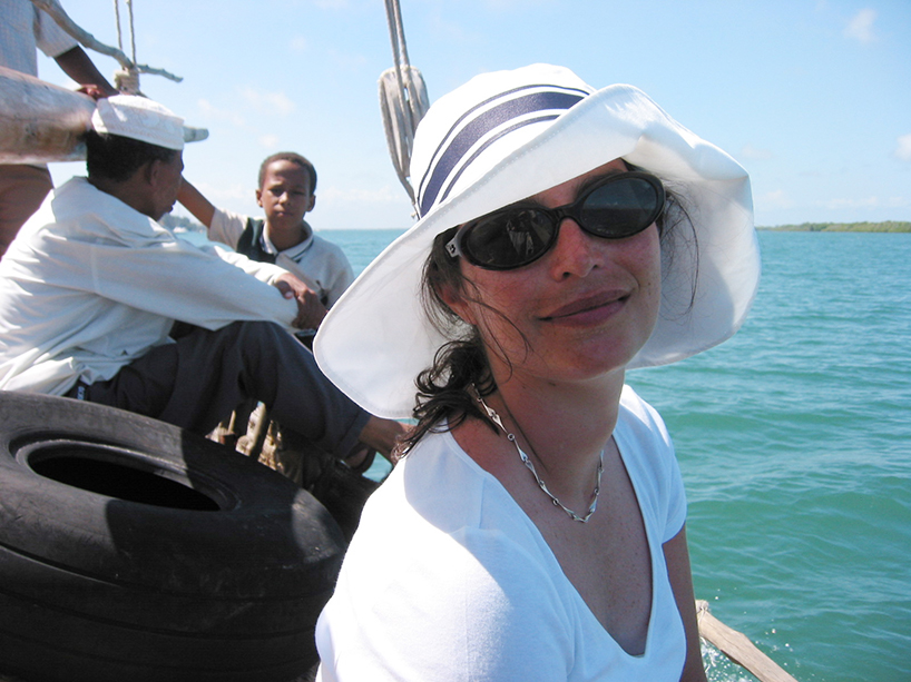 Courtenay wearing her Jackie O. hat, sailing the Indian Ocean. Lamu Island, Kenya