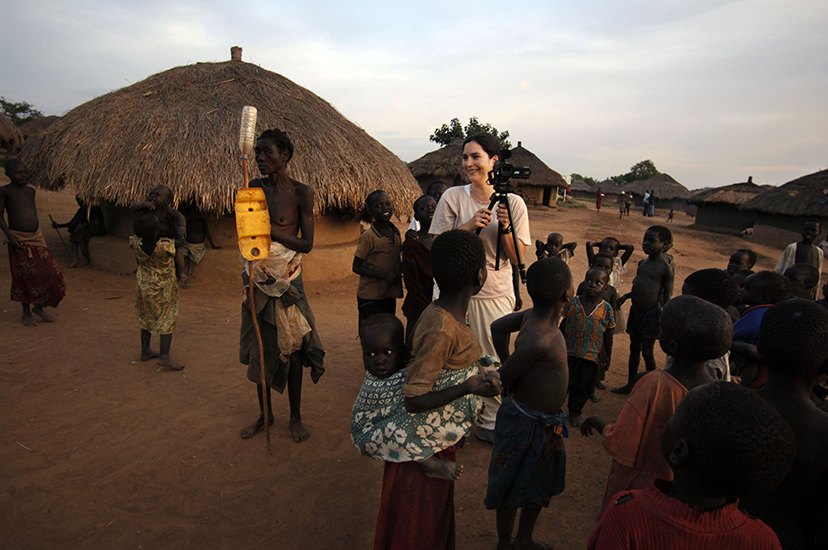 Courtenay filming a Ugandan refugee camp