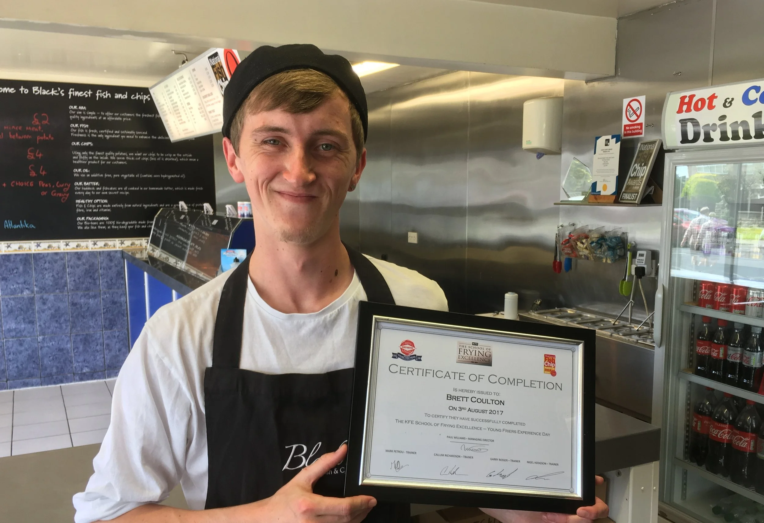 Brett Coulton of Black's Finest Fish & Chips, proudly sporting his certificate from the KFE School of Frying Excellence.