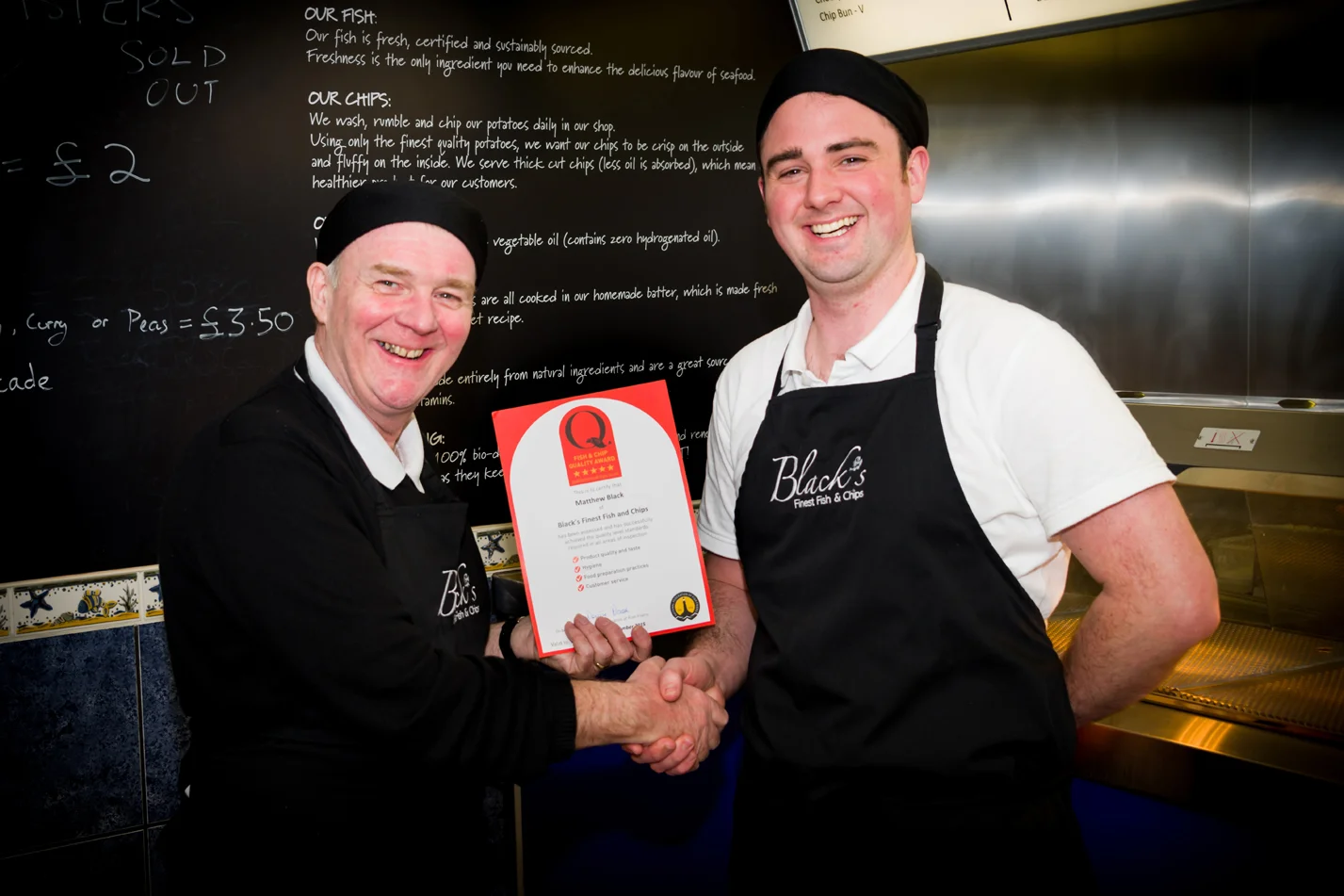 Matthew from Black’s Finest Fish and Chips is presented with the NFFF Quality Award by John ‘Gilly’ Gilmore from BBC Radio Lancashire.