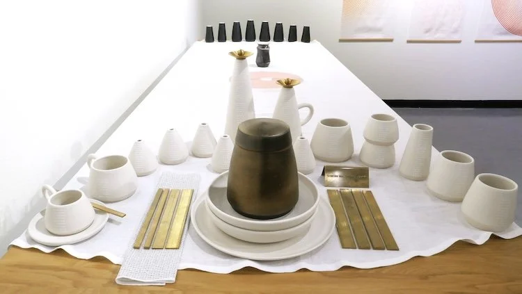   Someone was, Someone wasn’t (23 million minutes).  Porcelain, matte glaze, gloss glaze, iron oxide, screen print, linen and brass; 40 x 72 x 37 in. 