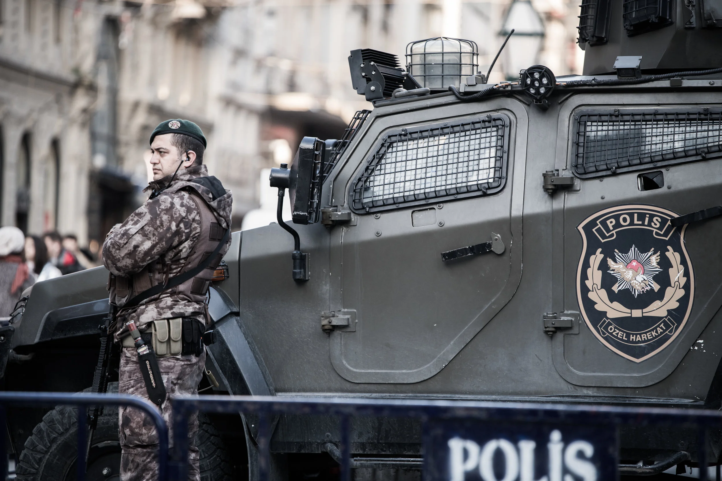 A Turkish security officer standing next to an armoured vehicle keeping a watchful eye in Istiklal Street