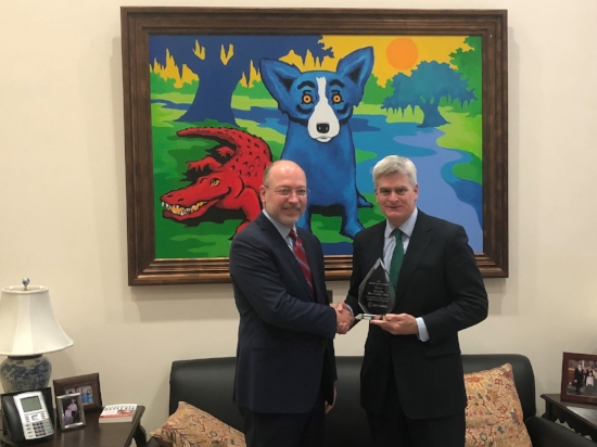 CAHC President Joel White presents the Affordability Champion award to Sen. Cassidy