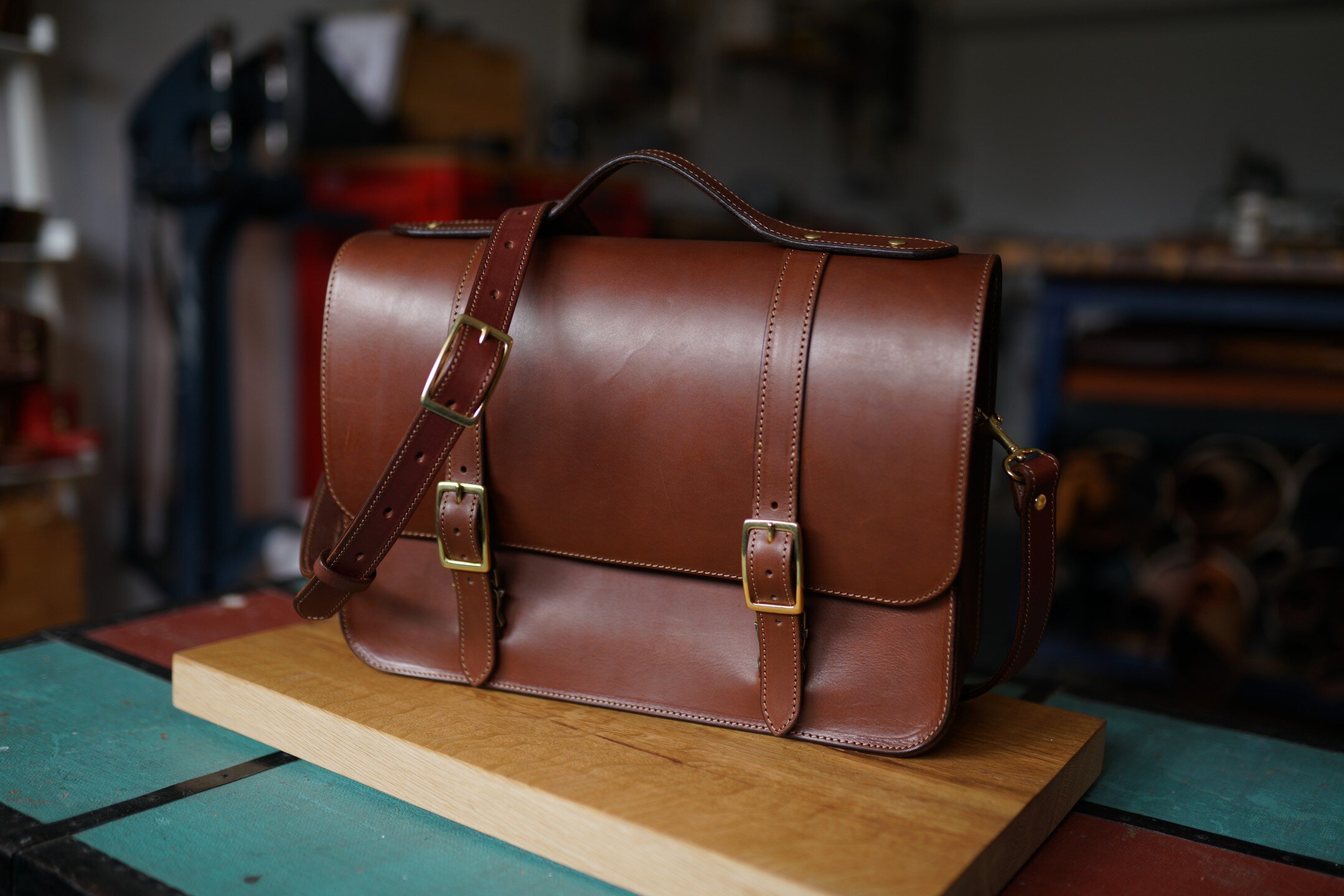 Custom messenger-briefcase, 15.5&quot; x 11&quot; using 6oz bridle leather throughout. Interior pocket panels, side snap key holder, custom embossing, solid brass hardware, and a fully adjustable crossbody strap with sliding shoulder pad.
.
#leather 