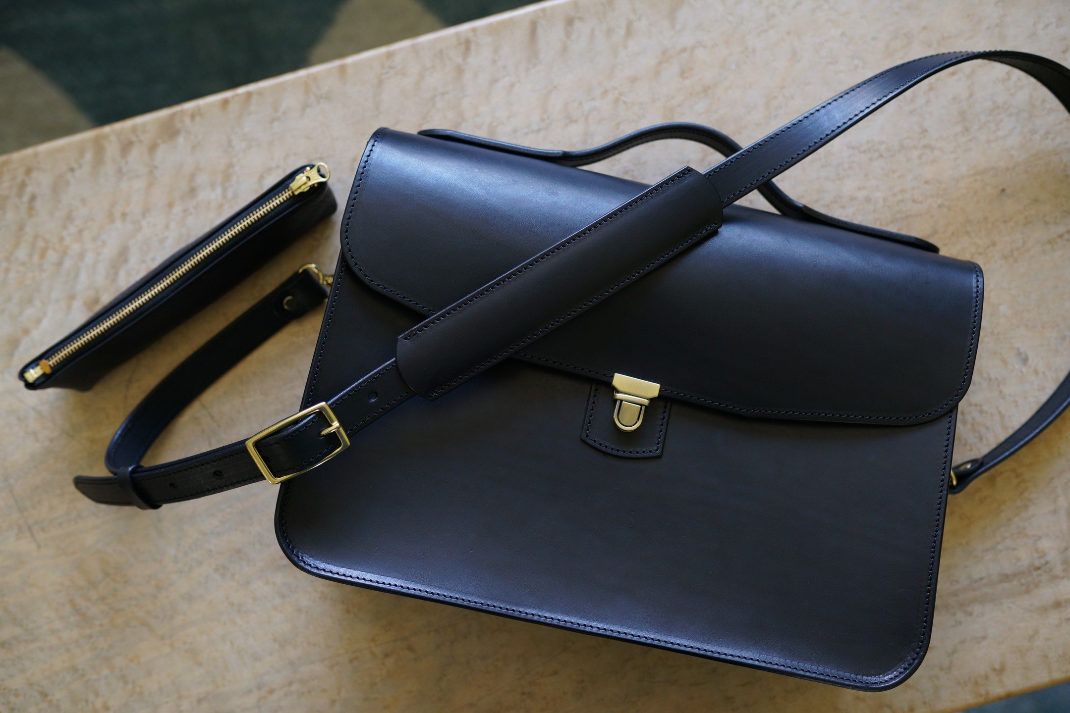 Another custom messenger bag&ndash;&ndash;this time in 5/6oz black bridle leather with solid brass hardware. Tons of pocket options inside plus an added zipper pouch for writing implements. Made to fit a 16&rdquo; Macbook Pro with lots of room for da