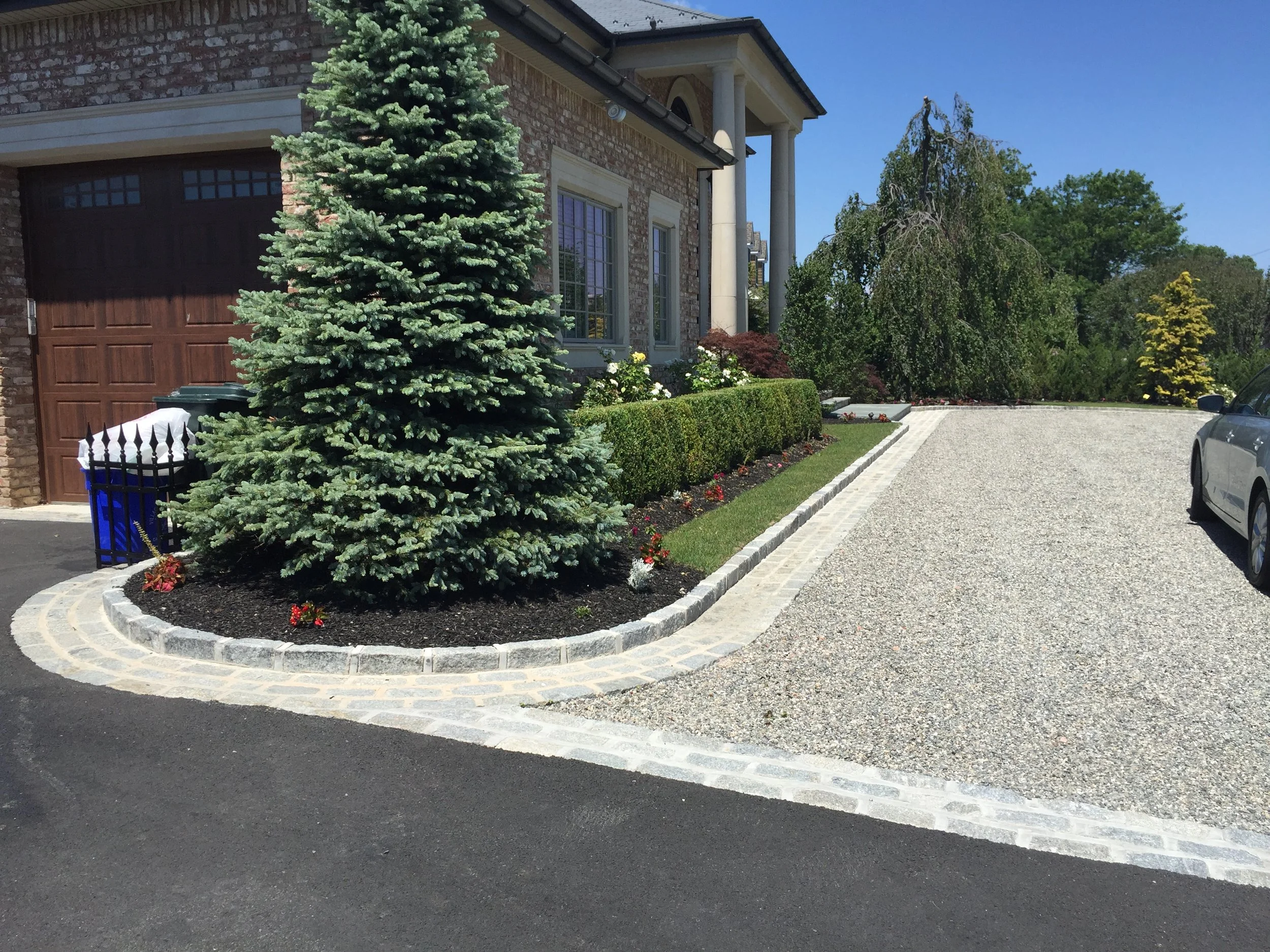 Landscape design with custom paved driveway in Long Island, NY​​​​​​​