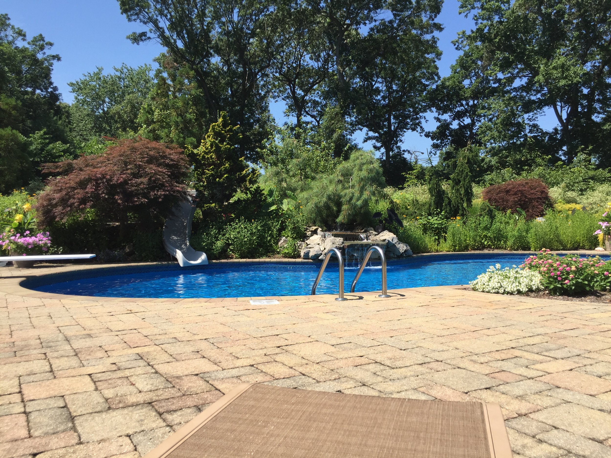 Top landscape design company with pool waterfall in Long Island, NY