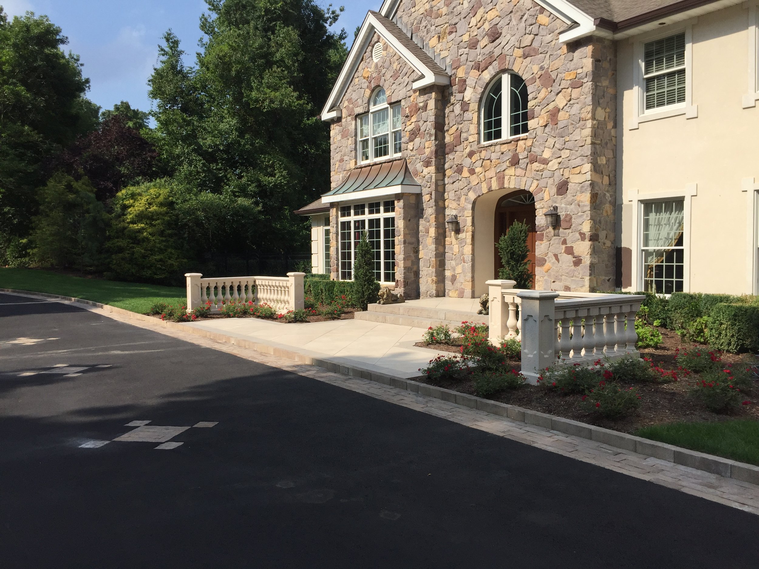 Professional landscape design with a paved walkway in Long Island, NY