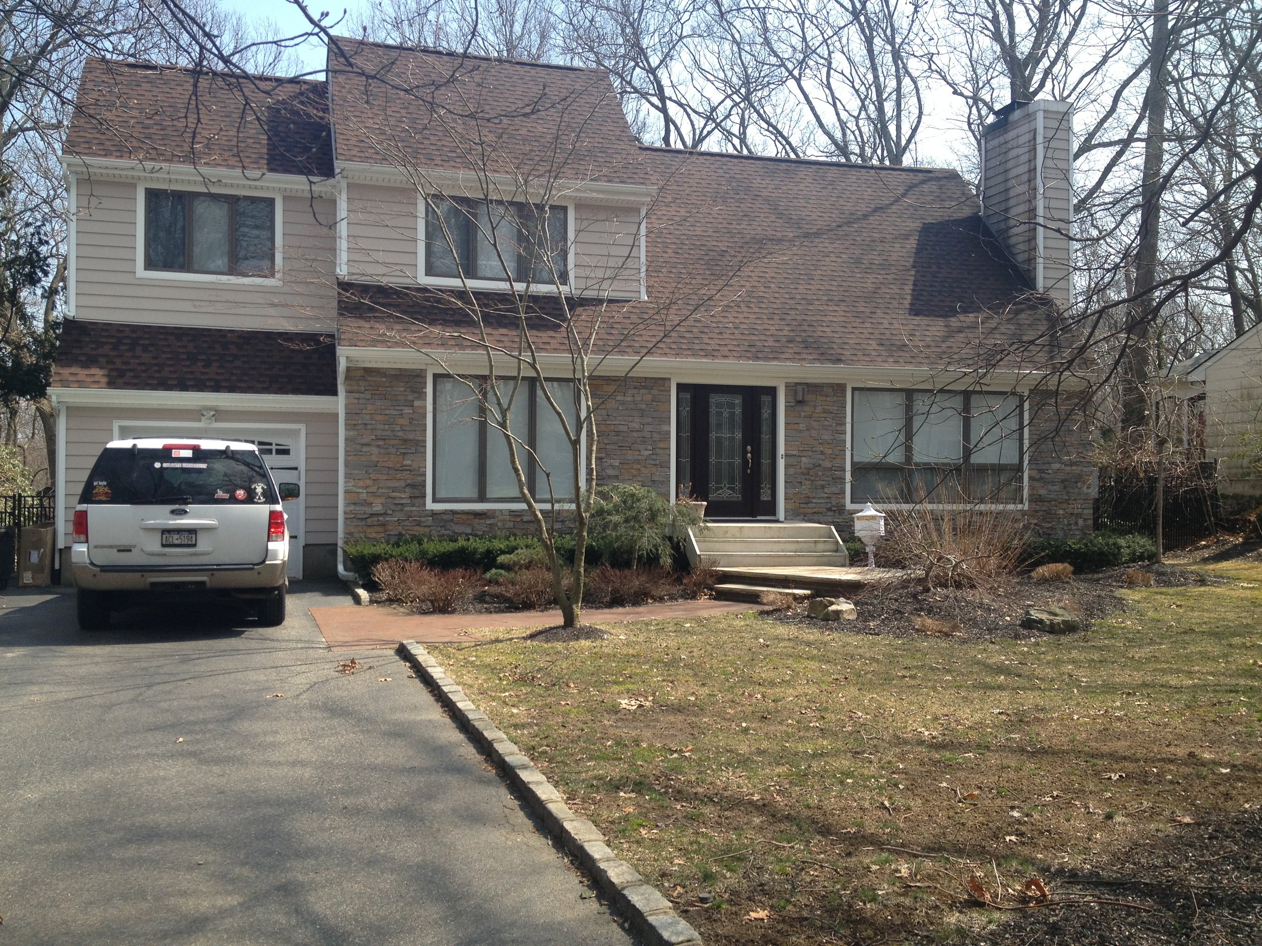 Landscape design with paved driveway in Long Island, NY