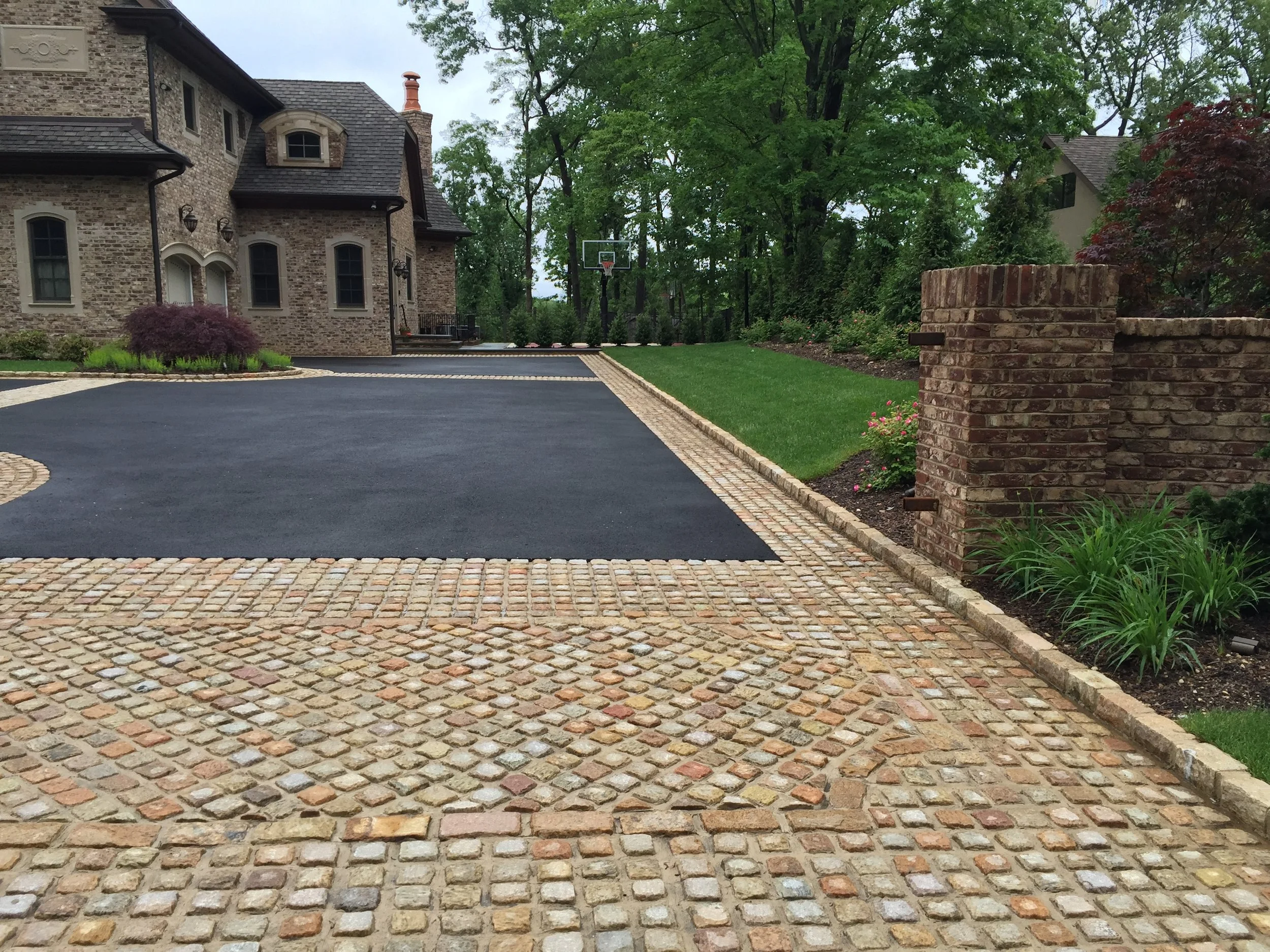 Landscape design with natural stone driveway in Long Island, NY