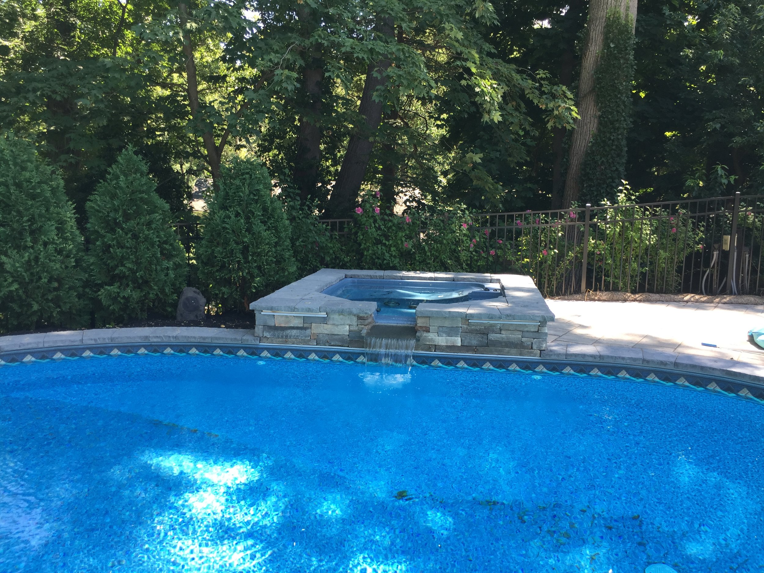 Landscape design with pool waterfall in Long Island, NY​​​​​​​