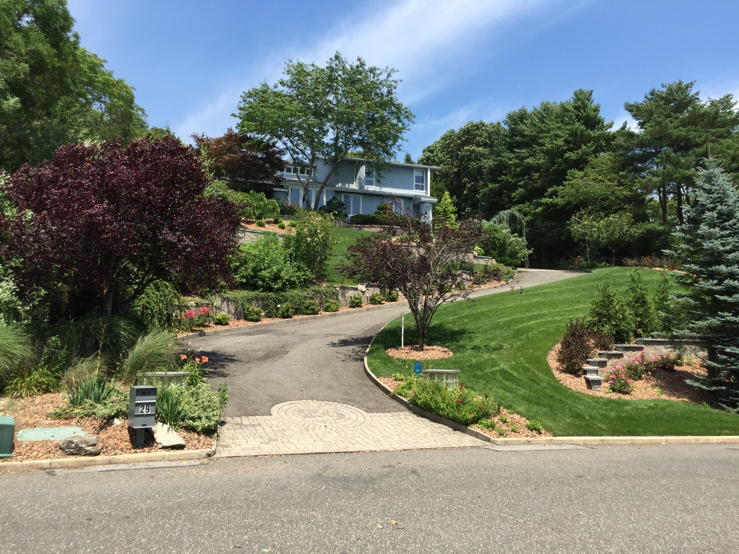Landscape design with paved driveway in Long Island, NY​​​​​​​