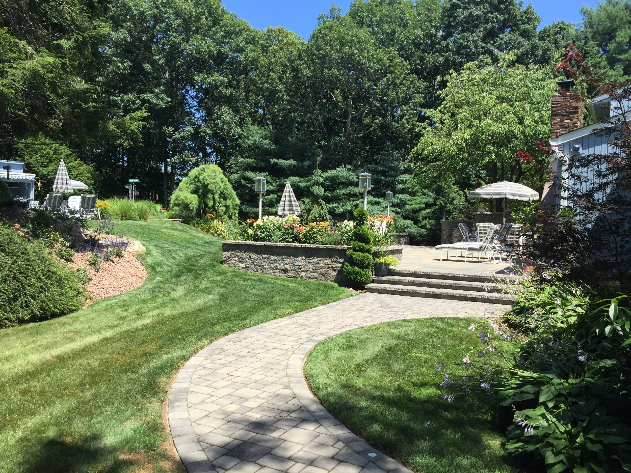 Landscape design with paved walkway in Long Island, NY​​​​​​​