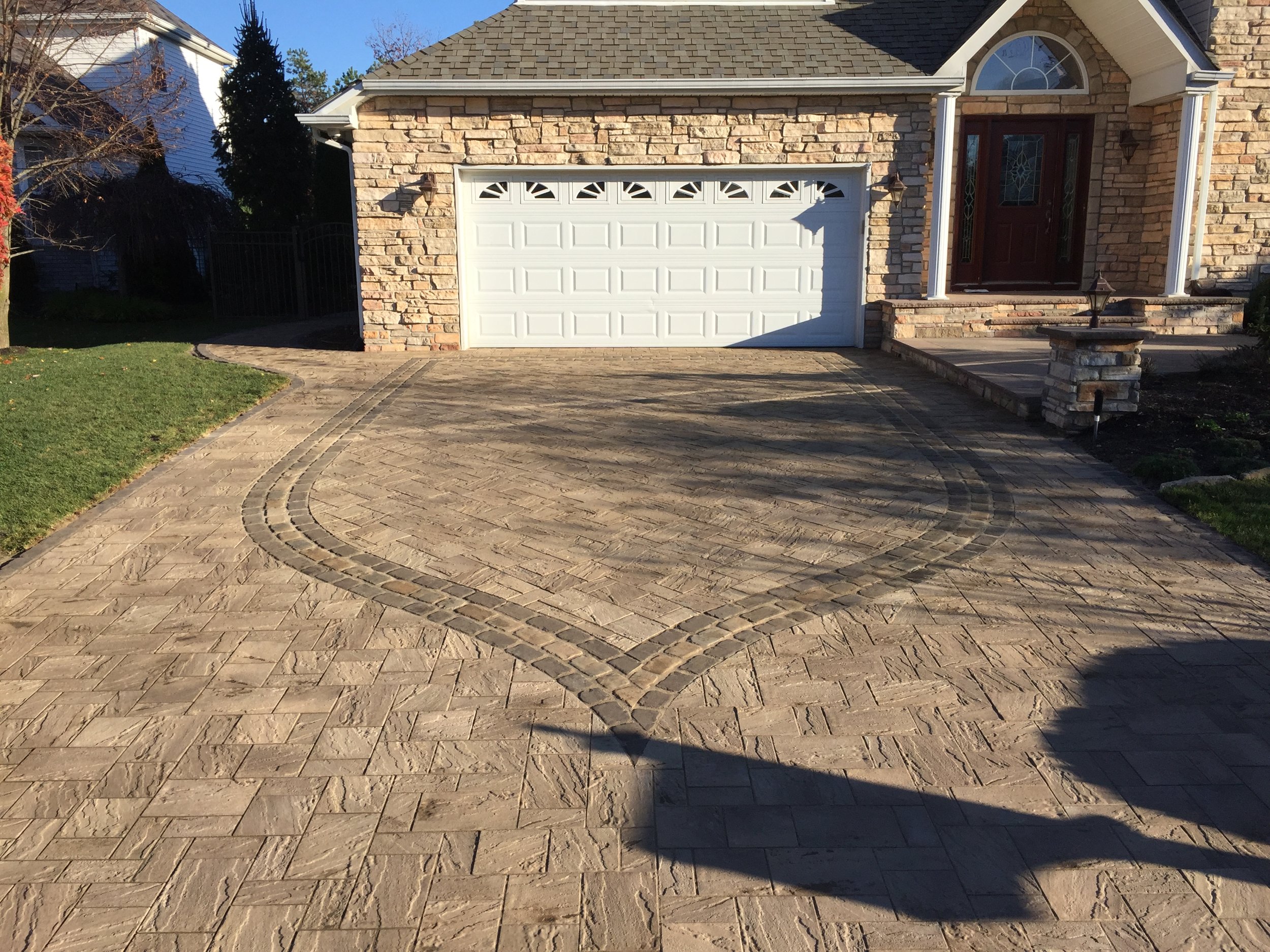 Landscape design with paved driveway in Long Island, NY​​​​​​​