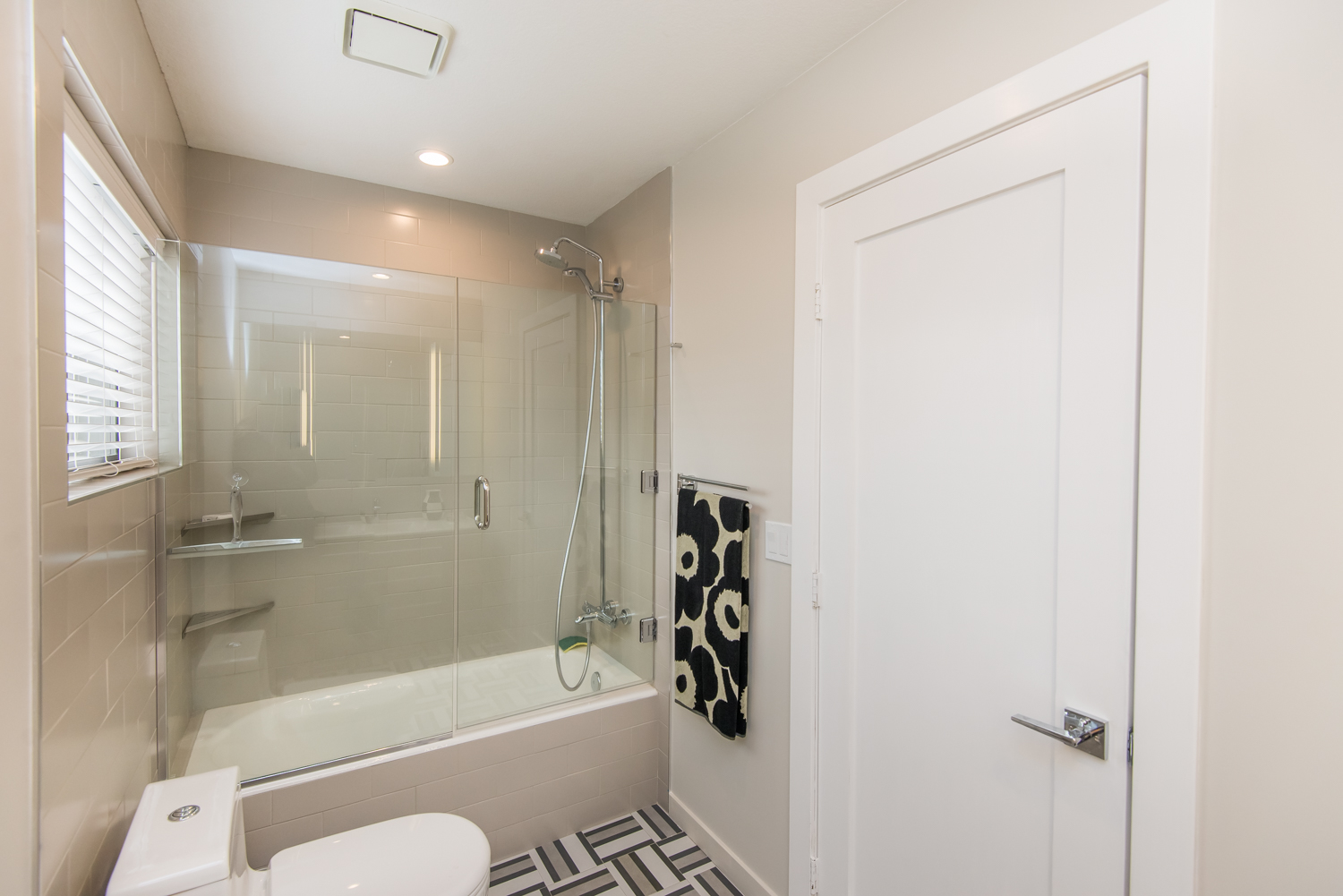 Tub-shower with glass enclosure completes the master bath.