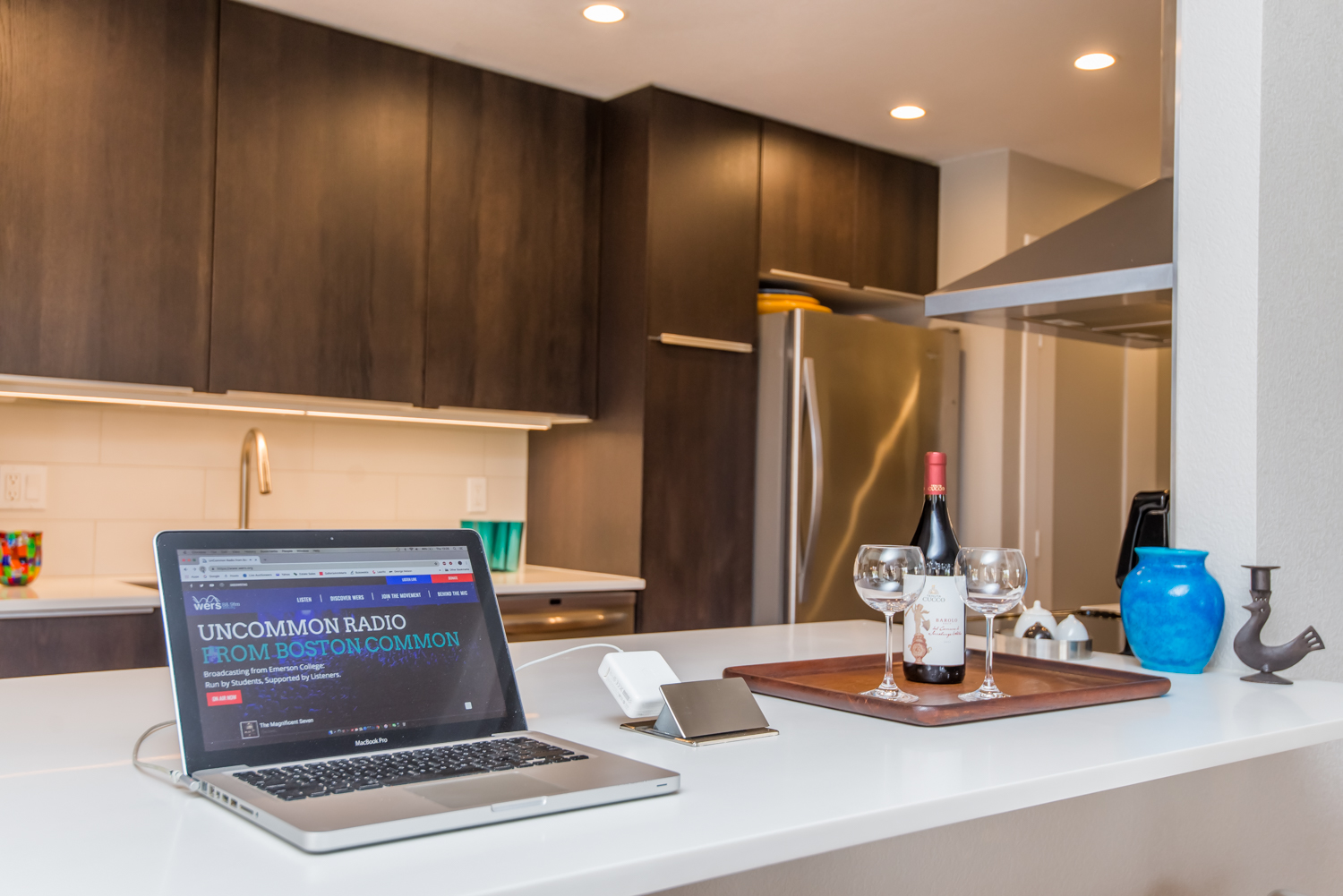 Kitchen bar features a pop-up outlet for laptops or phone charging.
