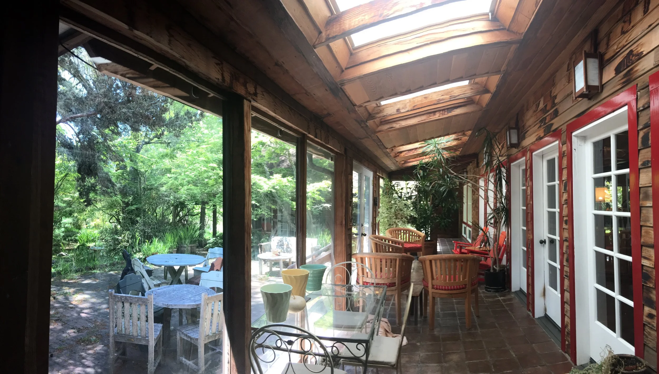 Enclosed porch at back of home looking onto patio
