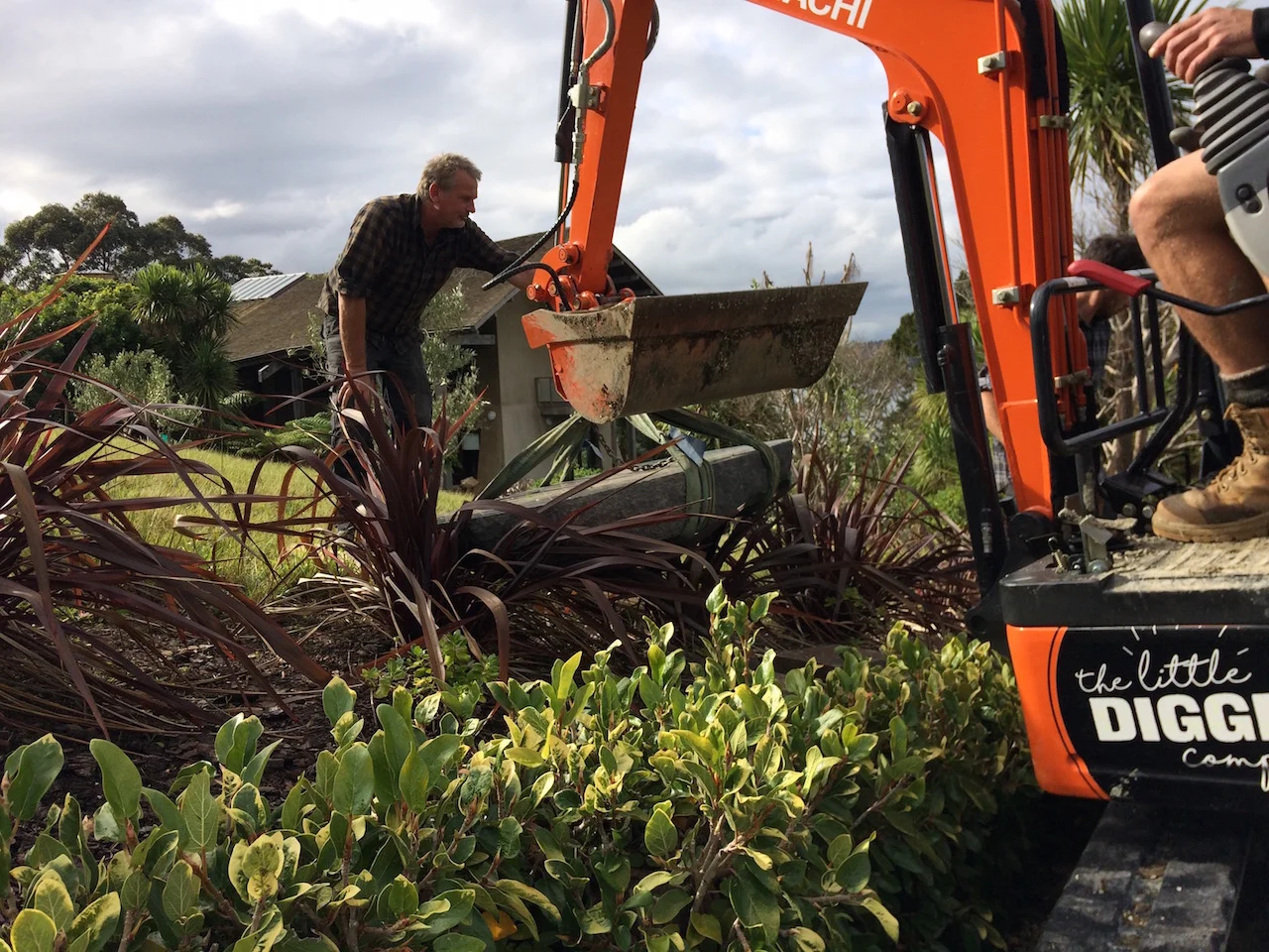 Snells Beach: 400kg Stone Plinth The challenge to manoeuvre a 400kg stone up stairs and over the hill at Brick Bay. No problem for The Little Digger